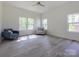 Bright bedroom with large windows, two armchairs, and neutral tones for a peaceful retreat at 2004 Plain Field Dr, Bessemer City, NC 28016