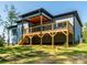 Back exterior showcasing a multi-tiered deck with stairs leading down to the grassy backyard at 2004 Plain Field Dr, Bessemer City, NC 28016