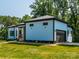 Side view of the house highlights the home's light blue siding and attached garage at 2004 Plain Field Dr, Bessemer City, NC 28016