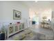 Open-concept foyer leading to the living area with a decorative cabinet and modern decor at 2004 Plain Field Dr, Bessemer City, NC 28016