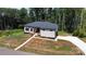 Aerial view showcasing a single-story house with a long driveway and spacious front yard at 2004 Plain Field Dr, Bessemer City, NC 28016