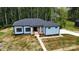 Charming blue home featuring an inviting entrance, a modern aesthetic, and professional landscaping at 2004 Plain Field Dr, Bessemer City, NC 28016