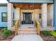 Welcoming front porch with brick pillars, wood accents, and a modern black front door at 2004 Plain Field Dr, Bessemer City, NC 28016