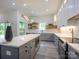Well-lit kitchen with a large island, modern appliances, and open shelving at 2004 Plain Field Dr, Bessemer City, NC 28016