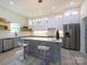Modern kitchen with gray and white cabinets, stainless steel appliances, and a large island at 2004 Plain Field Dr, Bessemer City, NC 28016