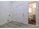 Spacious laundry area with plank flooring and access to the bathroom with tiled floors at 2004 Plain Field Dr, Bessemer City, NC 28016