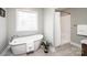 Bathroom includes a freestanding soaking tub and a shower with modern fixtures at 201 S 5Th Ave, Maiden, NC 28650