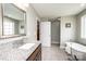 Bright bathroom features a soaking tub, a single vanity, and a large mirror at 201 S 5Th Ave, Maiden, NC 28650