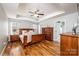 Comfortable primary bedroom features tray ceilings, an ensuite bath and hardwood floors at 201 S 5Th Ave, Maiden, NC 28650
