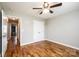 Bedroom with hardwood floors, a ceiling fan, and an open doorway at 201 S 5Th Ave, Maiden, NC 28650