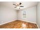 Bedroom with hardwood floors, neutral walls, a ceiling fan, and a window at 201 S 5Th Ave, Maiden, NC 28650