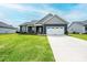 Charming home with blue siding, a well-manicured lawn, and a two-car garage at 201 S 5Th Ave, Maiden, NC 28650