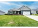 Charming one story home featuring a well maintained lawn, navy siding, and a two-car garage at 201 S 5Th Ave, Maiden, NC 28650