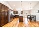 Full kitchen featuring stainless steel appliances, wood cabinets, granite counters and a dining table at 201 S 5Th Ave, Maiden, NC 28650