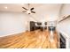 Expansive living area with hardwood flooring, featuring a kitchen and fireplace at 201 S 5Th Ave, Maiden, NC 28650