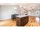 Open-concept living area with hardwood floors and a kitchen island with granite countertops at 201 S 5Th Ave, Maiden, NC 28650