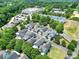 Scenic aerial view of a neighborhood showcasing houses, trees, and community buildings on a sunny day at 228 Coneflower Pl, Fort Mill, SC 29708