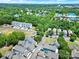 Aerial view of a neighborhood with mature trees, well-maintained homes, and green spaces at 228 Coneflower Pl, Fort Mill, SC 29708