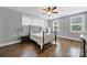 Bedroom boasts hardwood floors, large windows, a ceiling fan, and a beautiful metal bed frame at 228 Coneflower Pl, Fort Mill, SC 29708