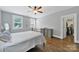 Inviting bedroom features an iron bed, hardwood floors, and a walk-in closet at 228 Coneflower Pl, Fort Mill, SC 29708