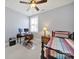 Cozy bedroom featuring a wood frame bed, a wooden desk with computers, and natural light at 228 Coneflower Pl, Fort Mill, SC 29708