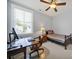 Serene bedroom with a wooden desk setup, neutral walls, and a ceiling fan at 228 Coneflower Pl, Fort Mill, SC 29708