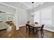Dining room with hardwood floors, decorative ceiling, modern chandelier, and natural light at 228 Coneflower Pl, Fort Mill, SC 29708