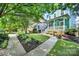 A beautifully landscaped yard and curved walkway lead to this charming blue two-story home at 228 Coneflower Pl, Fort Mill, SC 29708