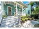 Inviting covered front porch with white railings, potted plants, and hanging ferns at 228 Coneflower Pl, Fort Mill, SC 29708