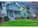 Charming blue two-story home with a welcoming front porch and well-manicured lawn at 228 Coneflower Pl, Fort Mill, SC 29708