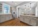 Open kitchen with stainless steel refrigerator, granite counters, and hardwood floors at 228 Coneflower Pl, Fort Mill, SC 29708