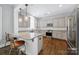Open kitchen features granite countertops, stainless steel appliances, and bar stool seating at 228 Coneflower Pl, Fort Mill, SC 29708