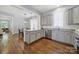 Bright kitchen featuring granite countertops, stainless steel appliances, and hardwood floors at 228 Coneflower Pl, Fort Mill, SC 29708