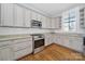Modern kitchen featuring stainless steel appliances, granite countertops, and hardwood floors at 228 Coneflower Pl, Fort Mill, SC 29708