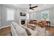Elegant living room with a fireplace, hardwood floors, and a comfortable sofa in neutral tones at 228 Coneflower Pl, Fort Mill, SC 29708
