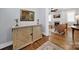 A foyer with a decorative wooden cabinet leads to an open living room with a fireplace at 228 Coneflower Pl, Fort Mill, SC 29708