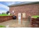 Exterior rear view of brick home featuring a cement patio, brick accents, and lush green grass at 2817 Long Cir # 1, Iron Station, NC 28080