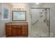 Bathroom featuring a wood vanity with granite countertops, a mirror, and a glass shower at 2817 Long Cir # 1, Iron Station, NC 28080