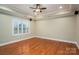 Bedroom featuring hardwood floors, a ceiling fan, and a window with shutters at 2817 Long Cir # 1, Iron Station, NC 28080
