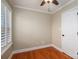 Bedroom featuring hardwood floors, a ceiling fan, and a white paneled door to the home's interior at 2817 Long Cir # 1, Iron Station, NC 28080