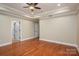 Bedroom featuring hardwood floors, a ceiling fan, recessed lighting, and access to two hallways at 2817 Long Cir # 1, Iron Station, NC 28080
