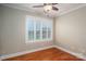 Comfortable bedroom featuring gleaming hardwood floors, a ceiling fan, and natural light from the window at 2817 Long Cir # 1, Iron Station, NC 28080