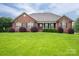 Charming brick home with lush lawn and well-manicured landscaping creates curb appeal at 2817 Long Cir # 1, Iron Station, NC 28080