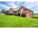 Beautiful brick home with manicured lawn, lush landscaping, and a welcoming front porch for relaxing at 2817 Long Cir # 1, Iron Station, NC 28080