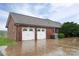 Spacious two-car garage with white doors and brick exterior, enhancing curb appeal at 2817 Long Cir # 1, Iron Station, NC 28080