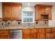 Kitchen featuring wood cabinets, stainless steel appliances, granite countertops, and a window at 2817 Long Cir # 1, Iron Station, NC 28080