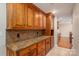 Kitchen featuring wood cabinets, granite countertops, tile backsplash, and stainless steel appliances at 2817 Long Cir # 1, Iron Station, NC 28080