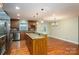 A kitchen with granite countertops, stainless steel appliances, a kitchen island, and hardwood floors at 2817 Long Cir # 1, Iron Station, NC 28080