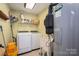 Functional laundry room featuring updated appliances and storage shelves for added convenience at 2817 Long Cir # 1, Iron Station, NC 28080