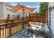 Enjoy the outdoors on this spacious deck, complete with comfortable seating and shaded by a large umbrella at 2945 Duvalla Ave, Charlotte, NC 28209
